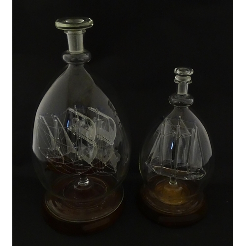 209 - Two 20thC glass ships in bottles on turned wooden stands, one titled Winston Churchill, the other Ma... 