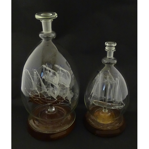 209 - Two 20thC glass ships in bottles on turned wooden stands, one titled Winston Churchill, the other Ma... 