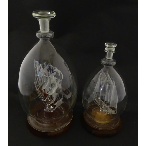 209 - Two 20thC glass ships in bottles on turned wooden stands, one titled Winston Churchill, the other Ma... 