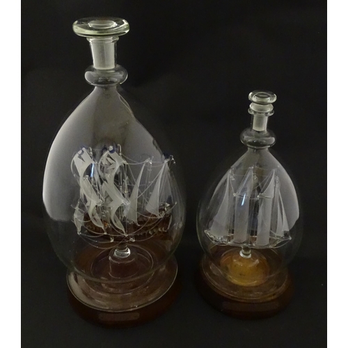 209 - Two 20thC glass ships in bottles on turned wooden stands, one titled Winston Churchill, the other Ma... 