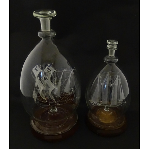 209 - Two 20thC glass ships in bottles on turned wooden stands, one titled Winston Churchill, the other Ma... 