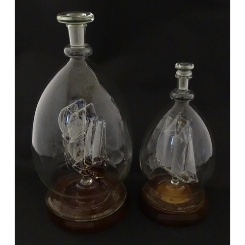 209 - Two 20thC glass ships in bottles on turned wooden stands, one titled Winston Churchill, the other Ma... 