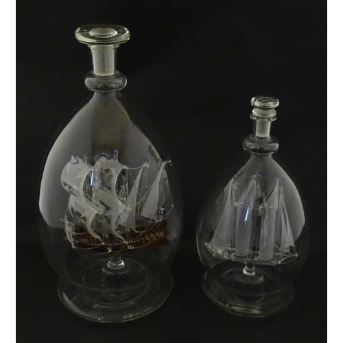 209 - Two 20thC glass ships in bottles on turned wooden stands, one titled Winston Churchill, the other Ma... 