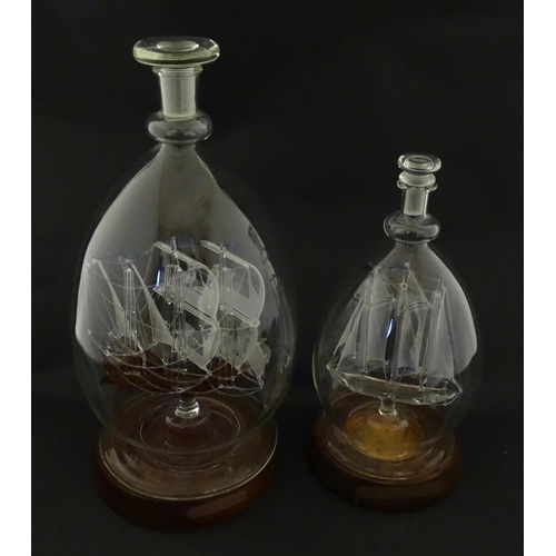 209 - Two 20thC glass ships in bottles on turned wooden stands, one titled Winston Churchill, the other Ma... 