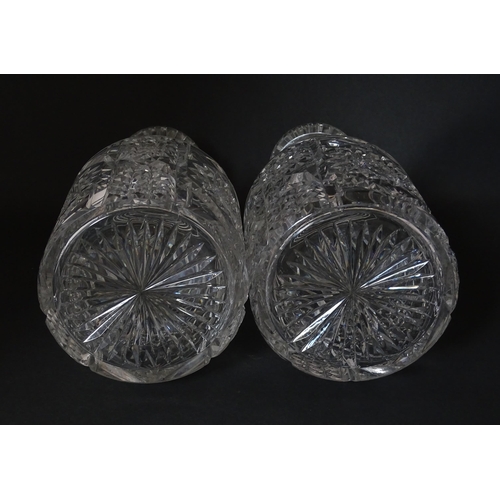 221 - A pair of cut glass / crystal decanters. Approx. 9 1/2