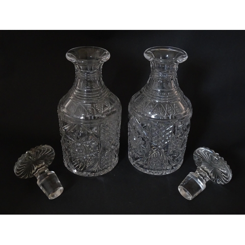 221 - A pair of cut glass / crystal decanters. Approx. 9 1/2