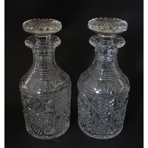 221 - A pair of cut glass / crystal decanters. Approx. 9 1/2