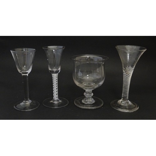 225 - Four assorted 18thC and later drinking glasses to include examples with air twist stems. Largest app... 