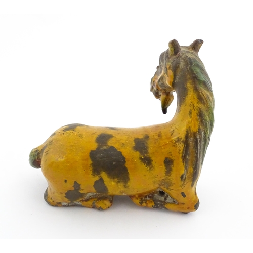 14 - A Chinese terracotta model of a Tang style horse. Approx. 4 3/4