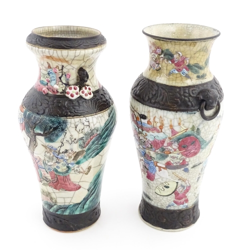 17 - Two Chinese twin handled vases with crackle glaze, decorated with figures in a landscape and auspici... 