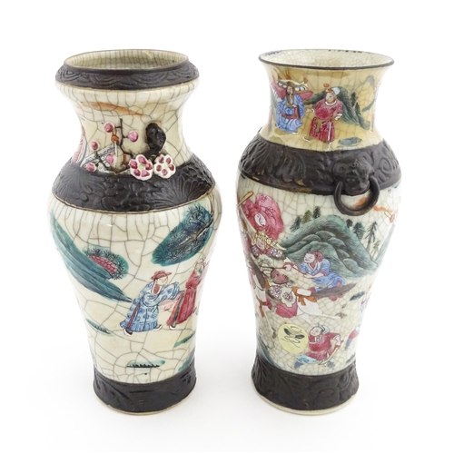 17 - Two Chinese twin handled vases with crackle glaze, decorated with figures in a landscape and auspici... 