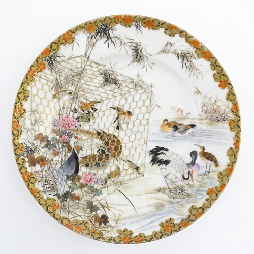 22 - A Japanese Kutani charger / dish decorated with various birds to include ducks, cranes, etc. Charact... 