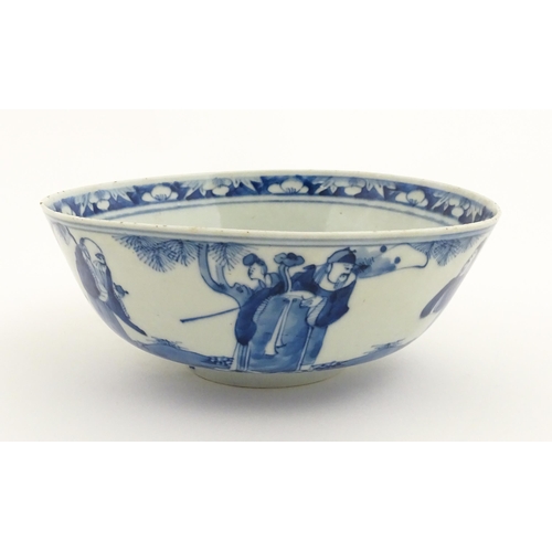 26 - A Chinese blue and white bowl decorated with elder figures in a landscape, the centre with a mountai... 