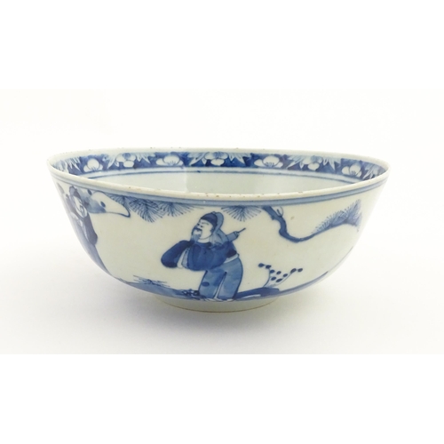 26 - A Chinese blue and white bowl decorated with elder figures in a landscape, the centre with a mountai... 