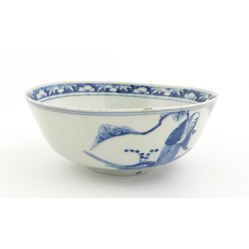 26 - A Chinese blue and white bowl decorated with elder figures in a landscape, the centre with a mountai... 