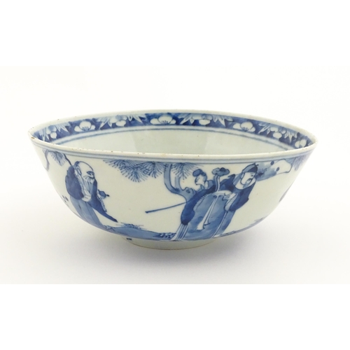 26 - A Chinese blue and white bowl decorated with elder figures in a landscape, the centre with a mountai... 