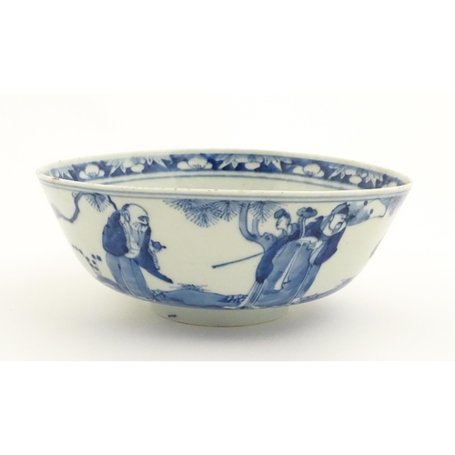 26 - A Chinese blue and white bowl decorated with elder figures in a landscape, the centre with a mountai... 