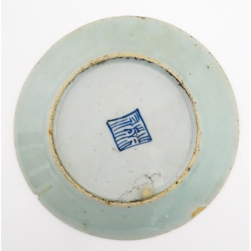 32 - Two Chinese / Cantonese plates decorated with flowers, foliage, insects and birds. Character marks u... 