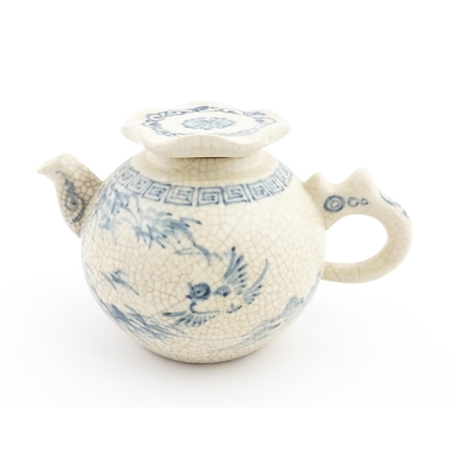 33 - A Chinese / Cantonese teapot decorated with figures, birds and flowers. Together with a Chinese blue... 