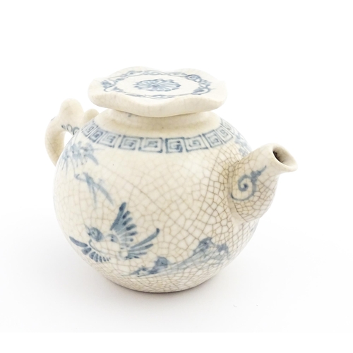 33 - A Chinese / Cantonese teapot decorated with figures, birds and flowers. Together with a Chinese blue... 