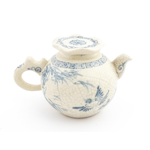 33 - A Chinese / Cantonese teapot decorated with figures, birds and flowers. Together with a Chinese blue... 