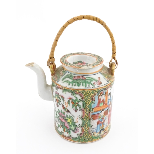 33 - A Chinese / Cantonese teapot decorated with figures, birds and flowers. Together with a Chinese blue... 