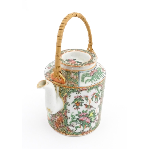 33 - A Chinese / Cantonese teapot decorated with figures, birds and flowers. Together with a Chinese blue... 