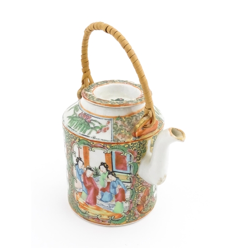 33 - A Chinese / Cantonese teapot decorated with figures, birds and flowers. Together with a Chinese blue... 