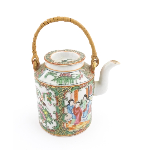 33 - A Chinese / Cantonese teapot decorated with figures, birds and flowers. Together with a Chinese blue... 