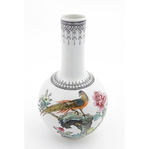 34 - A Chinese bottle vase decorated with a bird perched on a rocky outcrop with flowers and foliage, the... 