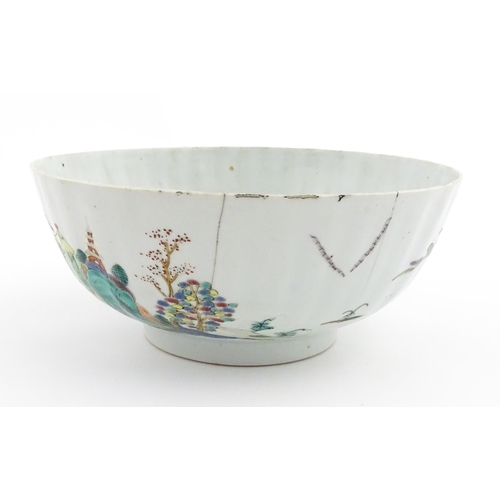 37 - A Chinese famille rose bowl decorated with a mountain landscape scene with pagoda style buildings. A... 