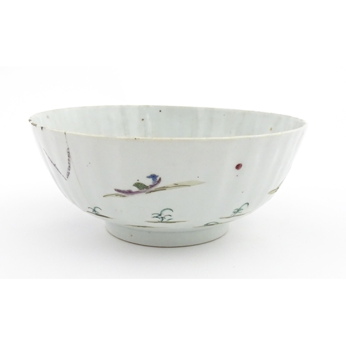 37 - A Chinese famille rose bowl decorated with a mountain landscape scene with pagoda style buildings. A... 