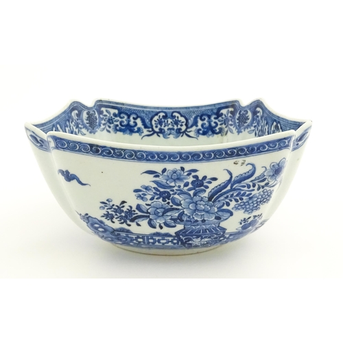 38 - A Chinese blue and white bowl of squared form decorated with flowers, foliage, taihu rock, bats in f... 