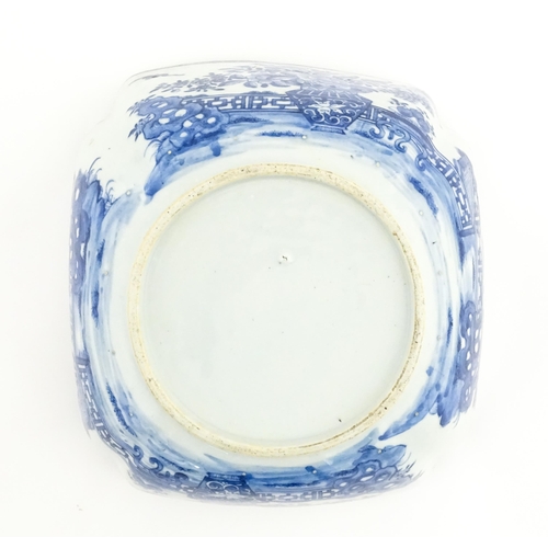 38 - A Chinese blue and white bowl of squared form decorated with flowers, foliage, taihu rock, bats in f... 