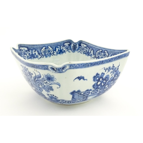 38 - A Chinese blue and white bowl of squared form decorated with flowers, foliage, taihu rock, bats in f... 