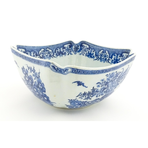 38 - A Chinese blue and white bowl of squared form decorated with flowers, foliage, taihu rock, bats in f... 