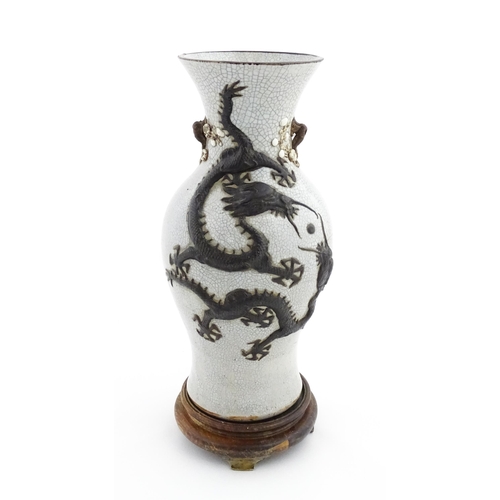 5 - A Chinese crackle glaze vase decorated in relief with dragons chasing the flaming pearl of wisdom. C... 