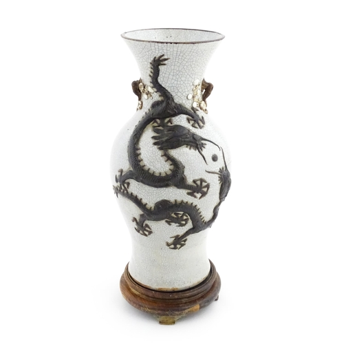 5 - A Chinese crackle glaze vase decorated in relief with dragons chasing the flaming pearl of wisdom. C... 