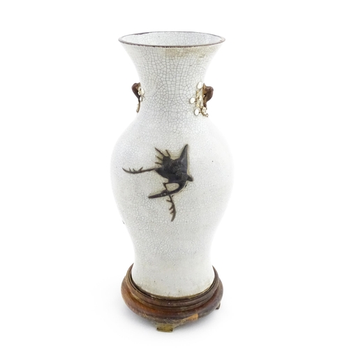 5 - A Chinese crackle glaze vase decorated in relief with dragons chasing the flaming pearl of wisdom. C... 