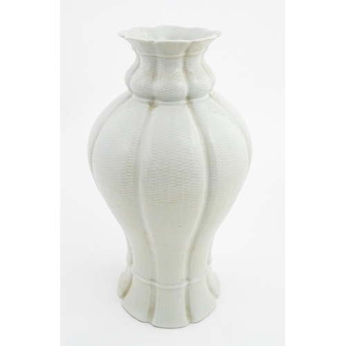 6 - An Oriental baluster vase of lobed form with basket weave style decoration. Approx. 17 1/4