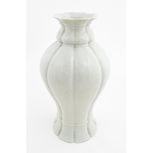 6 - An Oriental baluster vase of lobed form with basket weave style decoration. Approx. 17 1/4