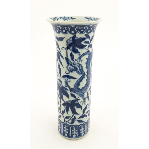 7 - A Chinese blue and white vase of cylindrical vase decorated with dragons, flowers and foliage. Appro... 