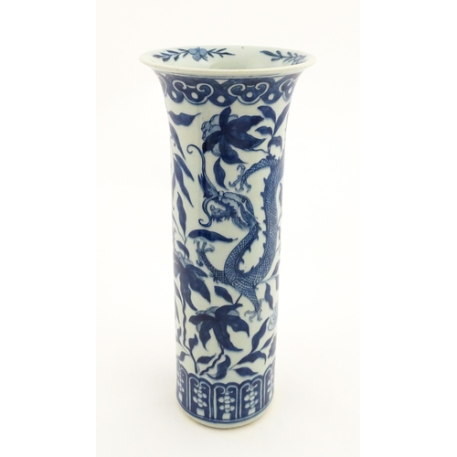 7 - A Chinese blue and white vase of cylindrical vase decorated with dragons, flowers and foliage. Appro... 