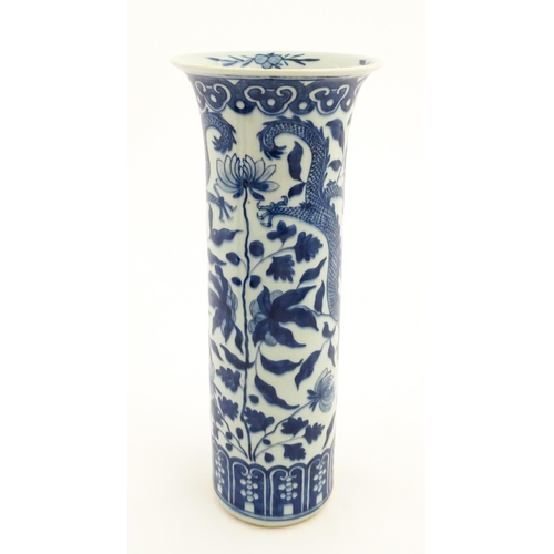 7 - A Chinese blue and white vase of cylindrical vase decorated with dragons, flowers and foliage. Appro... 