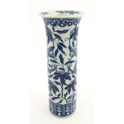 7 - A Chinese blue and white vase of cylindrical vase decorated with dragons, flowers and foliage. Appro... 