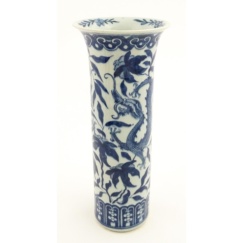 7 - A Chinese blue and white vase of cylindrical vase decorated with dragons, flowers and foliage. Appro... 