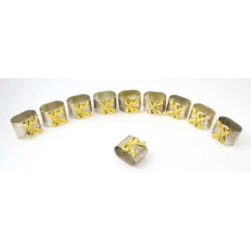 437 - Ten silver plate napkin rings with gilt bow detail.