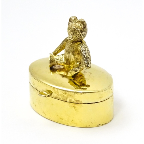 445 - A silver gilt pill box with teddy bear to top, hallmarked London 2001, maker Douglas Pell Silverware... 