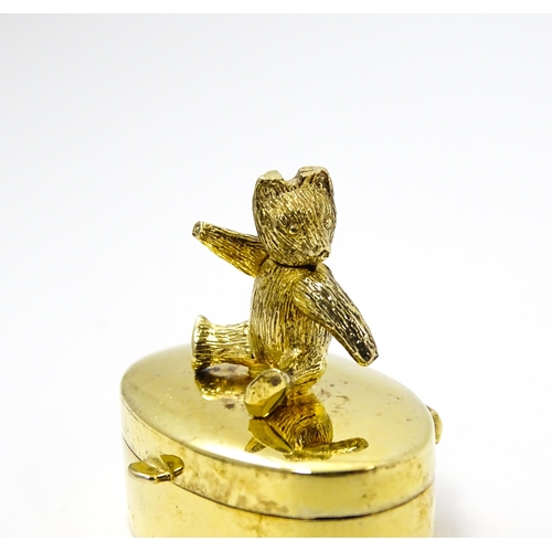 445 - A silver gilt pill box with teddy bear to top, hallmarked London 2001, maker Douglas Pell Silverware... 