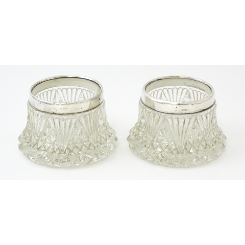 460 - A pair of cut glass salts with silver rims hallmarked London 1905. Approx. 2